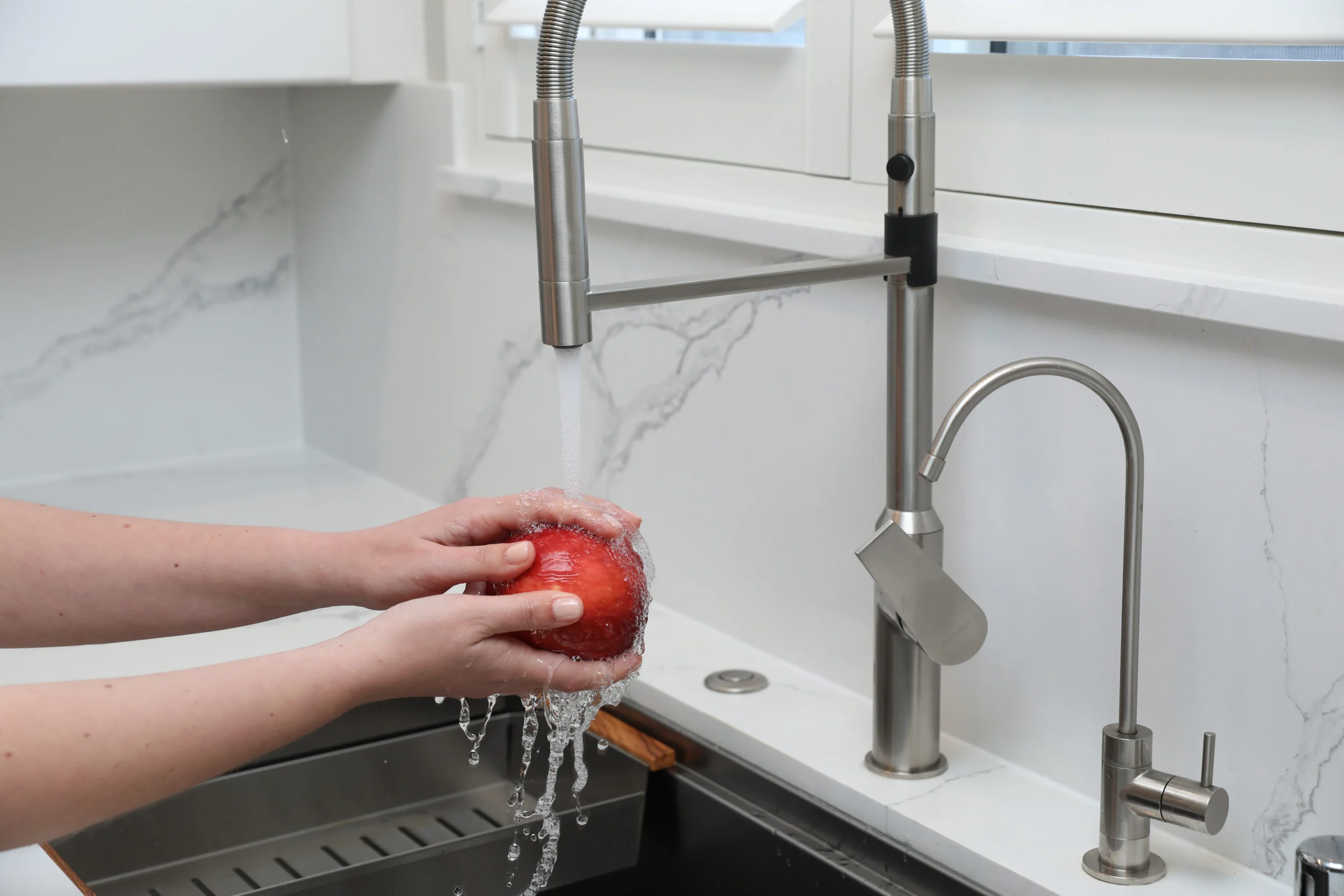 Plumber testing faucet connections for leaks
