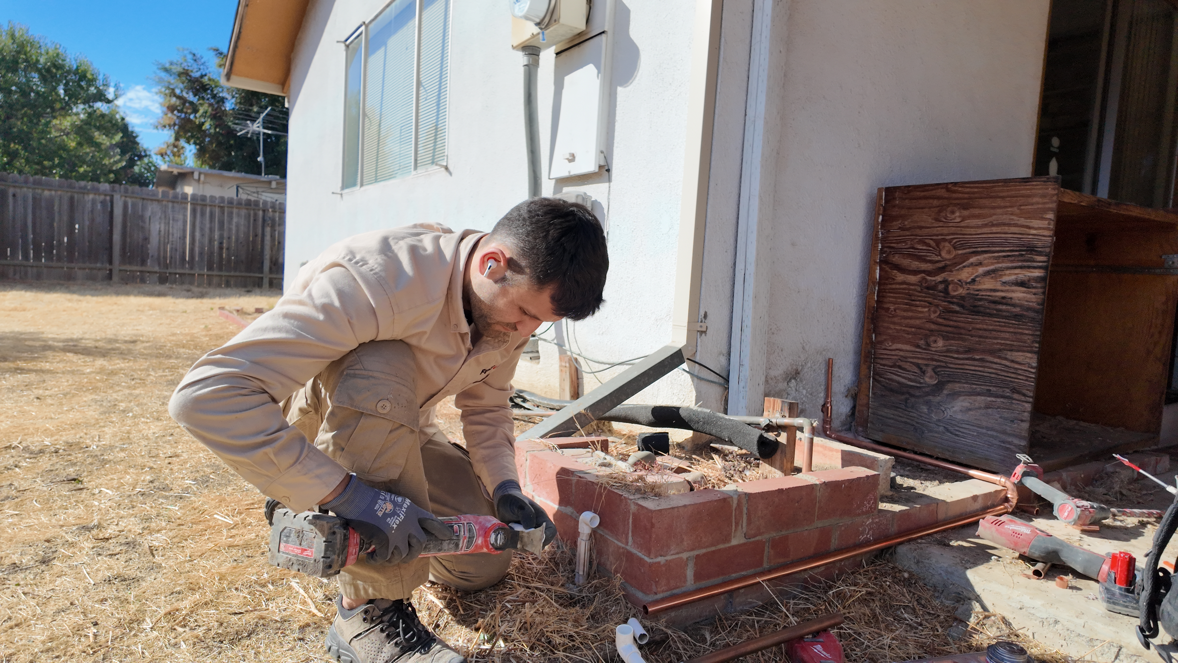 Plumber performing a pressure test after water line replacement 