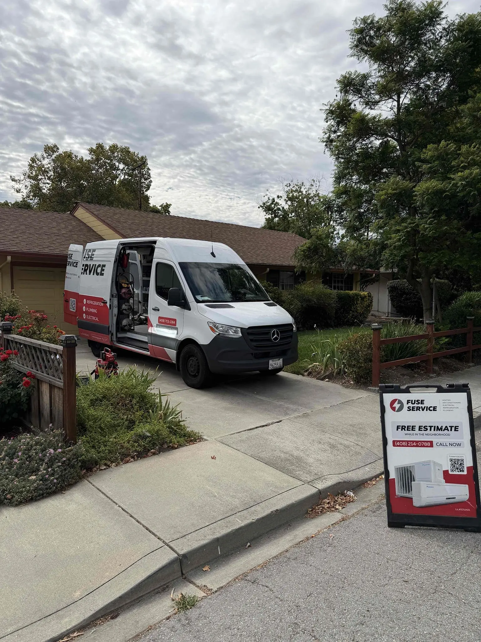 HVAC technician performing heat pump maintenance at a Bay Area home before El Niño